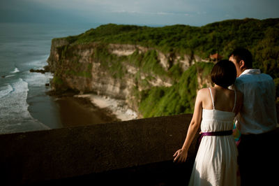 Rear view of couple looking at sea