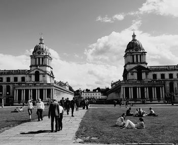 Group of people in front of building against sky