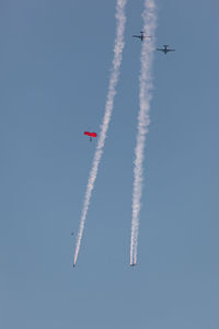 Red devils free jumping team in sky with airplanes