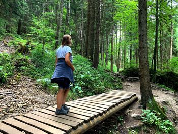 Woman walking in forest