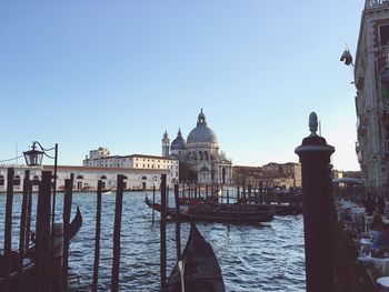 View of church by sea against clear blue sky