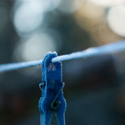 Close-up of icicles hanging on metal fence during winter
