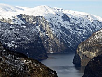 Scenic view of sea and mountains against sky