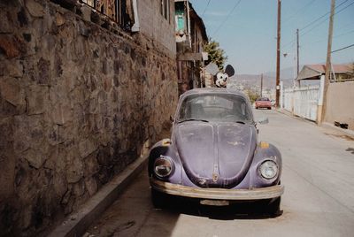 Vintage car on street against building