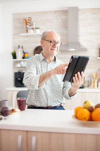 Man using digital tablet at home