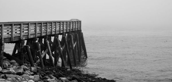 Pier over sea against clear sky