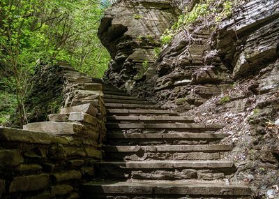 Low angle view of old steps amidst rock formation