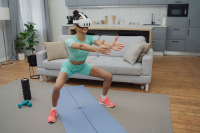 Full length of woman exercising in gym