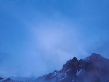 Low angle view of mountain against blue sky