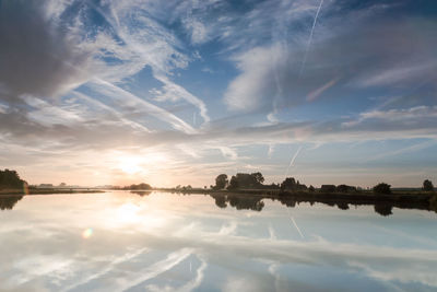 Scenic view of lake against sky during sunset