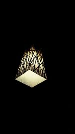 Low angle view of lit lamp hanging on ceiling