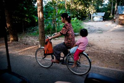 Full length of woman riding bicycle