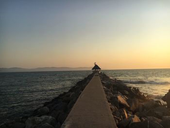 Scenic view of sea against clear sky during sunset