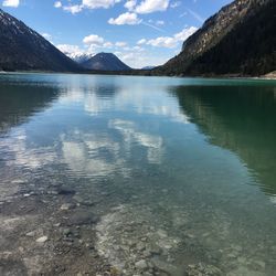 Scenic view of lake and mountains against sky