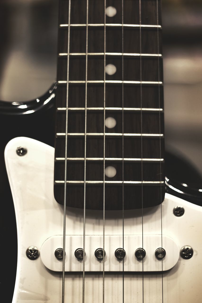 CLOSE-UP OF GUITAR AND PIANO