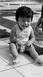 Portrait of cute boy sitting on floor