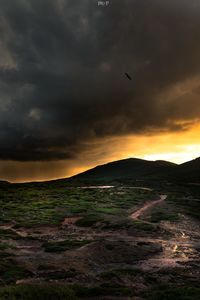 Scenic view of landscape against cloudy sky