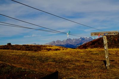 Low angle view of overhead cable car against sky