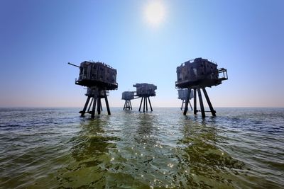 Lifeguard hut in sea against clear sky