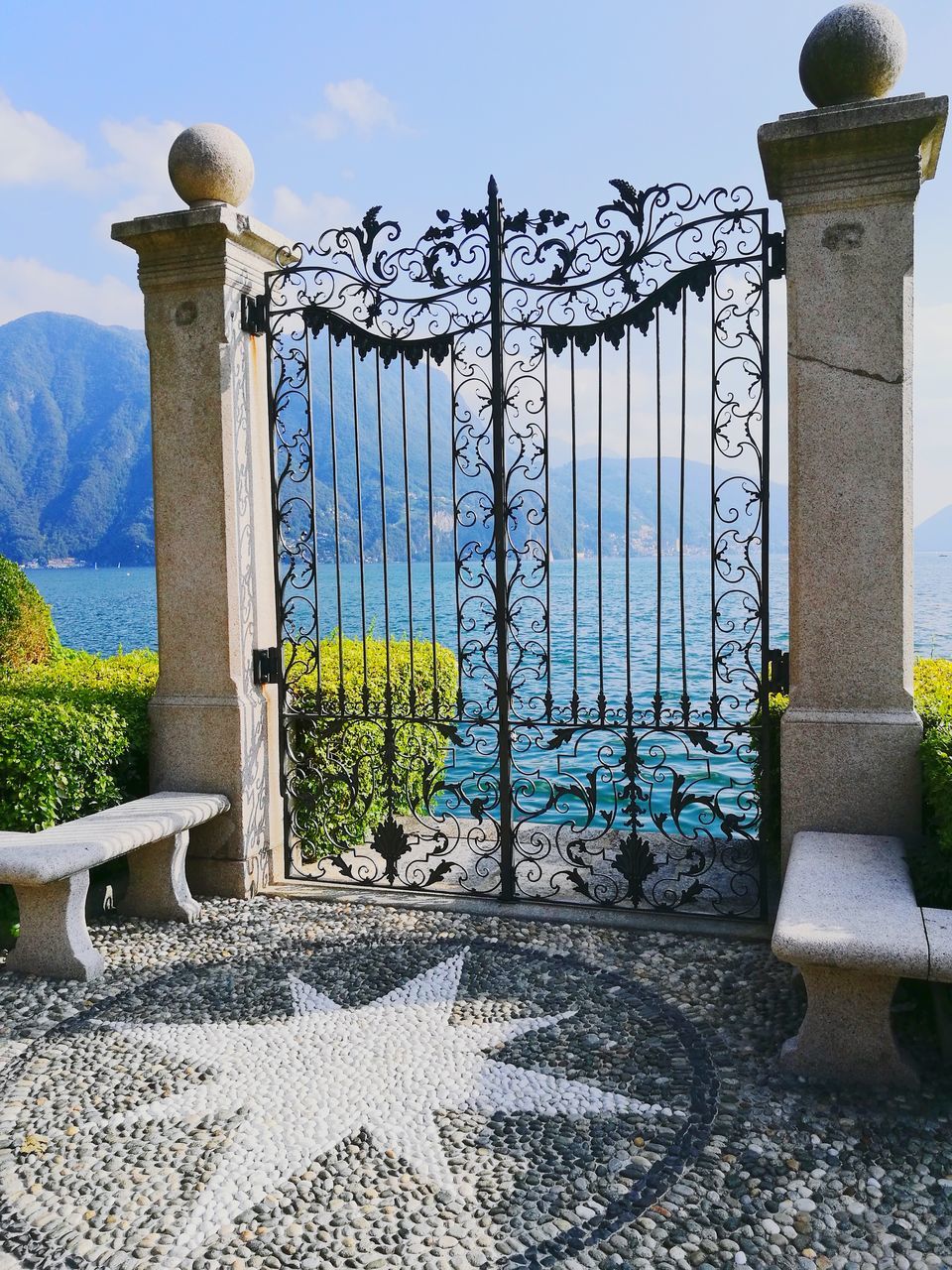 no people, architecture, built structure, nature, day, gate, sky, metal, water, sunlight, security, protection, outdoors, closed, barrier, boundary, fence, building exterior, entrance, architectural column