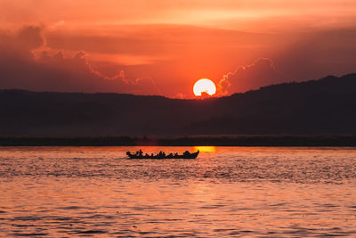 Scenic view of sea against orange sky