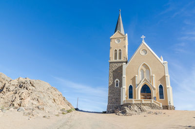 Panoramic view of felsenkirch church against clear blue sky in luderitz, namibia