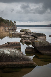 Rocks on beach against sky