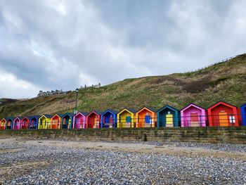 Houses by sea against sky