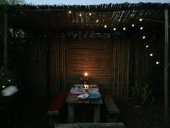 Illuminated lanterns hanging on table in building