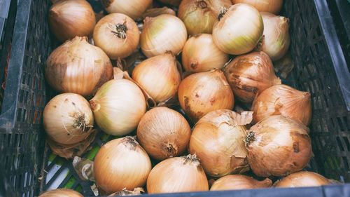 High angle view of onions in basket for sale at market