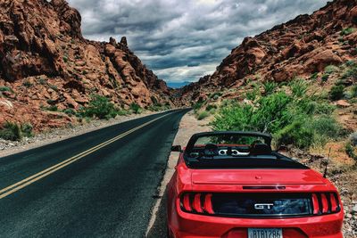 Red car on road against sky