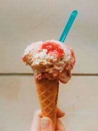 Close-up of hand holding ice cream