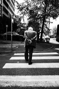 Rear view of girl walking on road