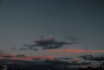 Low angle view of silhouette moon against sky at sunset