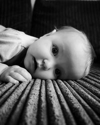 Portrait of cute baby lying on bed