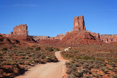 Rock formations on landscape against blue sky