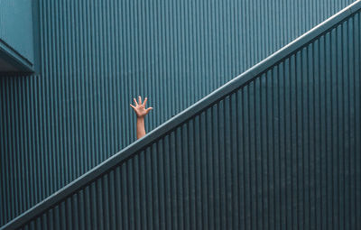 Hand sign on minimal staircase