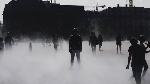 Group of people walking in front of buildings