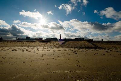 View of beach against cloudy sky