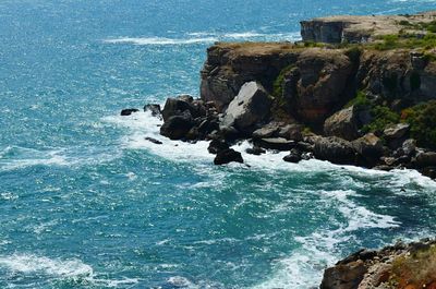 Rock formation in sea against sky