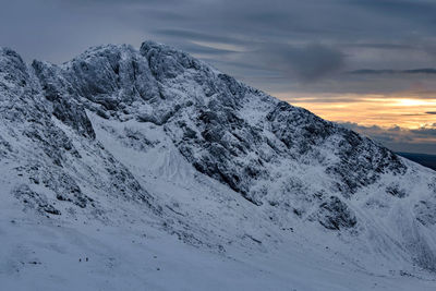 Scafell crag in winter with 2 tiny people