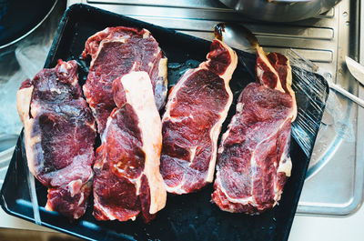 High angle view of meat on barbecue grill