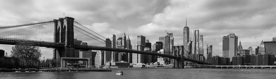 View of suspension bridge against cloudy sky