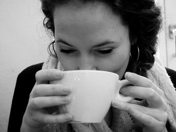 Close-up of young woman drinking coffee