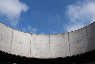 Low angle view of curved building against sky