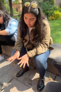 Full length of woman sitting outdoors