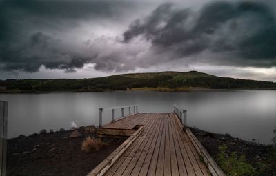 Pier over lake against sky