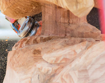 Close-up of equipment on wooden sculpture