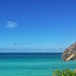 Scenic view of sea against blue sky