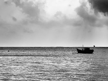 Boat sailing in sea against sky